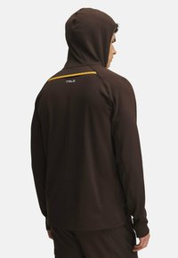 Brown hoodie with a textured finish, featuring a yellow accent stripe and logo on the back. Long sleeves with a snug fit.
