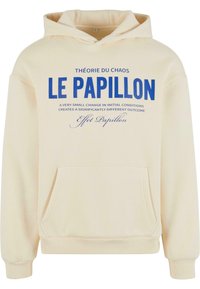 Crème hoodie met een voorzak. Heeft blauwe tekst op de borst: "THÉORIE DU CHAOS LE PAPILLON" en een gedetailleerde quote eronder.