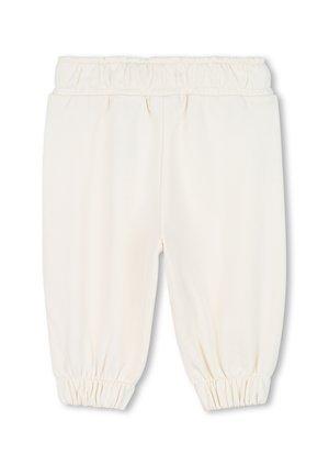Pantalons de sudation de couleur crème clair avec une taille élastique froncée et des poignets, fabriqués en tissu doux, présentant une texture lisse et un design simple.