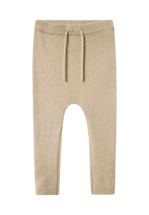 Beige Strickhose mit strukturierter Oberfläche, ausgestattet mit einem elastischen Bund und einem Kordelzug. Mit schmal zulaufenden Beinen und einem knöchellangen Schnitt gestaltet.