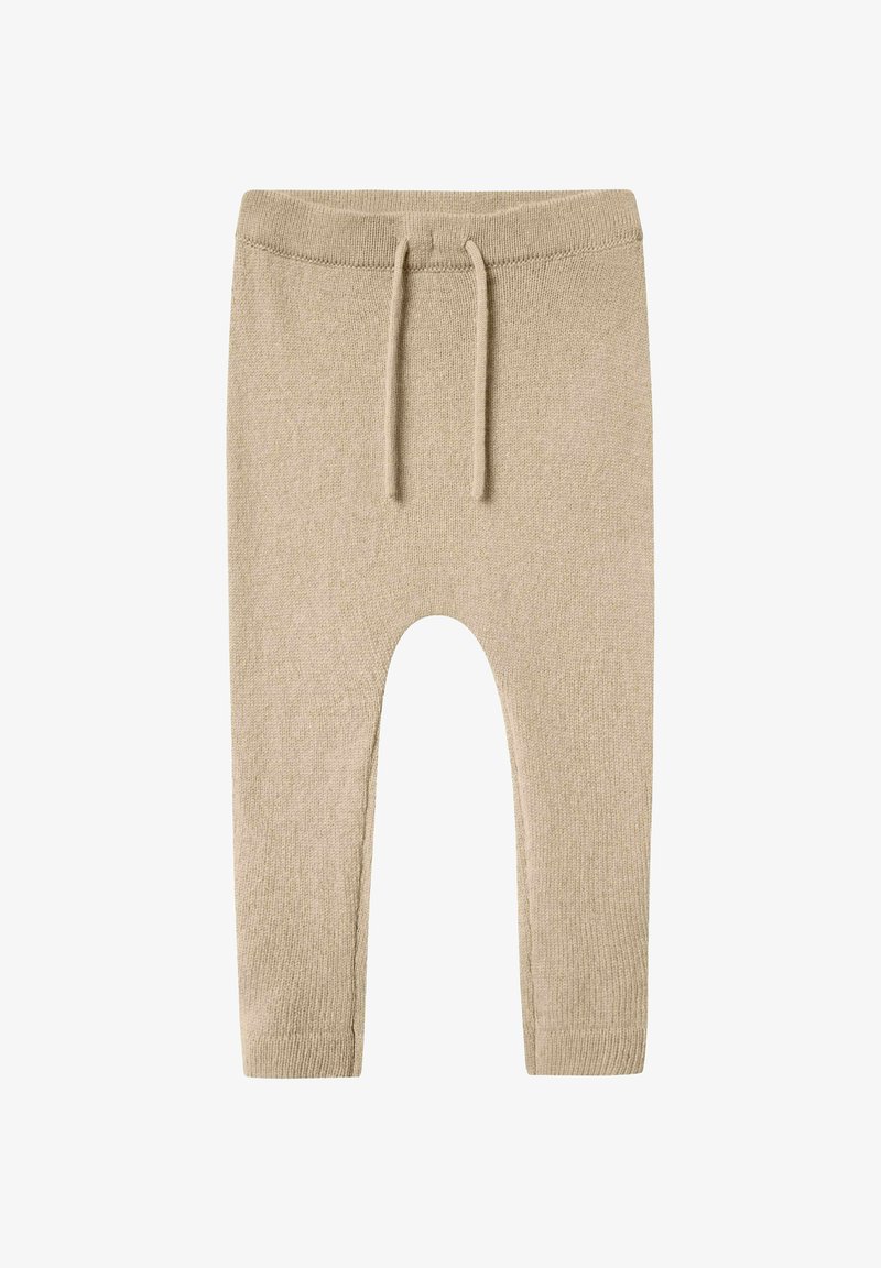 Beige knitted pants with a textured finish, featuring an elastic waistband and drawstring. Designed with tapered legs and an ankle-length cut.