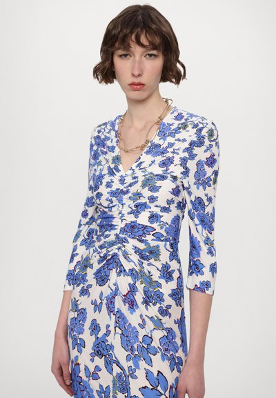 Floral dress with blue and green patterns on a white background, featuring a V-neck, three-quarter sleeves, and gathered detailing.