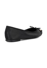 Black leather ballet flat featuring a rounded toe, small bow detail, and subtle gold accent at the front. Flat sole for ease of wear.