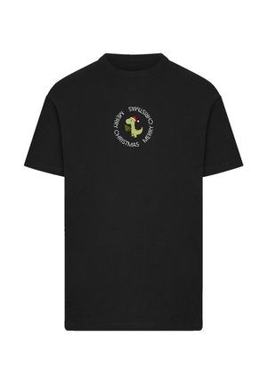 Black cotton t-shirt featuring a circular white text design with "Merry Christmas" and a graphic of a dinosaur in a Santa hat.