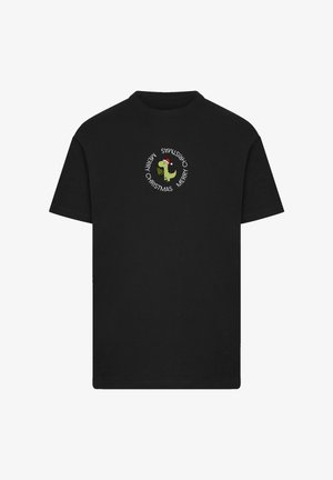 Black cotton t-shirt featuring a circular white text design with "Merry Christmas" and a graphic of a dinosaur in a Santa hat.