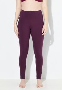 Leggings burdeos hechos de tela elástica, de longitud completa, con una cinturilla alta de textura suave y sin costuras visibles.
