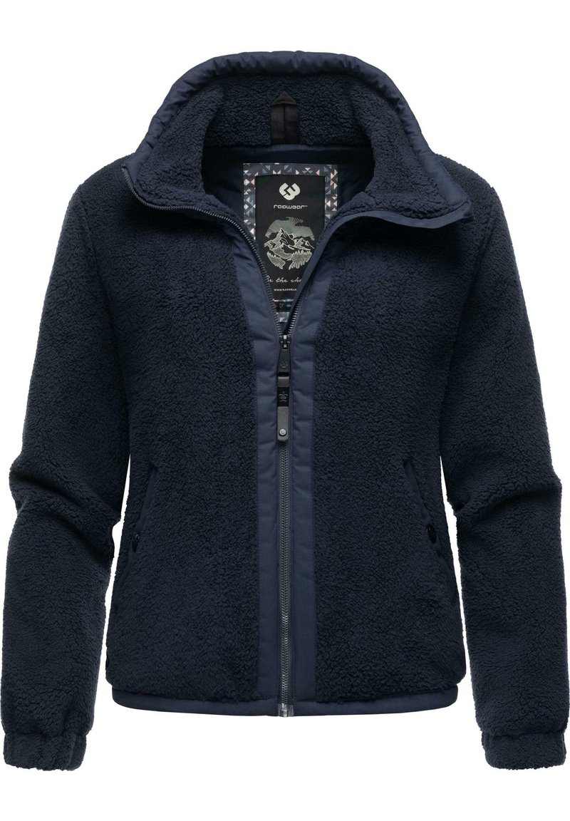 Giacca in pile blu navy con zip frontale, tessuto strutturato, colletto alto e tasche laterali. L'etichetta interna presenta una grafica di una montagna.