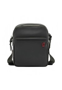 Sac bandoulière noir avec une finition lisse et mate, doté d'une fermeture éclair argentée, d'une sangle ajustable et d'un petit logo rouge à l'avant.