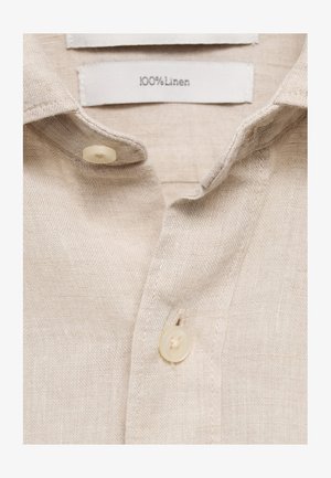 Harmaa pellavapaita, jossa on pehmeä rakenne, kaulusrintamus ja kaksi kermaista muovista nappia. Hoito-ohjeet lukevat "100 % pellavaa."