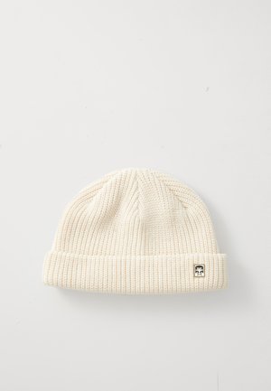Cream knitted beanie with a ribbed texture and a cuffed edge. Features a small black logo label on the side.