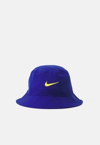 Blue bucket hat made of fabric with a yellow Nike logo on the front. Features a wide, downward-sloping brim and stitched details.