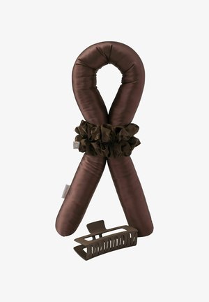 Brown padded neck pillow with a scrunchie wrapped around it and a matching brown hair claw clip placed below.