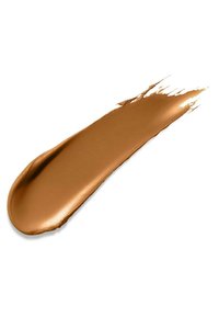 Cremige Bronzer-Testfläche in warmem Bronzeton, glatte Textur mit glänzendem Finish, vor einem weißen Hintergrund präsentiert.