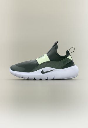 Dark green and light green Nike slip-on sneaker with white sole and "Just Do It" text on the side, displayed on a neutral background.