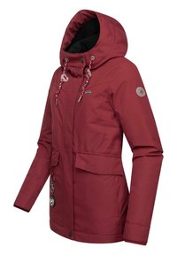 Red waterproof jacket featuring a hood, two front pockets, adjustable drawstrings, and a circular logo on the sleeve. Smooth texture.