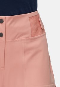 Rosa hochgeschnittene Shorts aus glattem Stoff, mit strukturierten Seitenpaneelen, zwei großen Metallknöpfen und einer eleganten Silhouette.