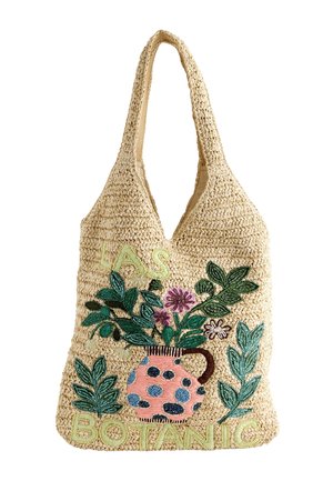 Beige vævet tote-taske med en lyserød prikket vase med grønne blade og lilla blomster, med "LAS BOTANIC" broderet i lys grøn.