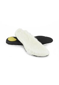 Svarta och vita sulor med ett fluffigt vitt överlager och en slät svart botten. Gula detaljer vid hälen ger kontrast.