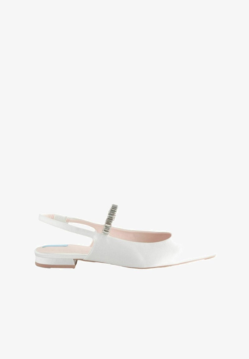 Chaussure plate blanche avec un talon arrière, à bout pointu, texture lisse, accessoires argentés sur la bride et une semelle intérieure délicate rose.