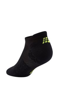 Calza nera corta con lavorazione a maglia testurizzata, caratterizzata da motivi a contrasto verdi. Orlo elasticizzato per una vestibilità sicura. Progettata per comfort e durata.