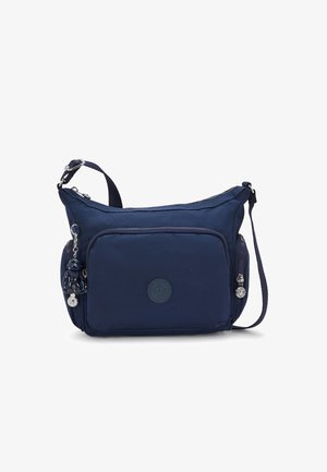 Navy blue shoulder bag made of durable fabric, featuring a main compartment, front zip pocket, and decorative keychain with a small figure.