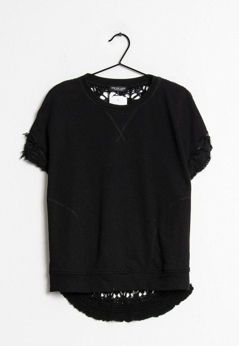 Sweat-shirt noir à manches courtes avec poignets et ourlet texturés, suspendu sur un cintre noir sur fond blanc.