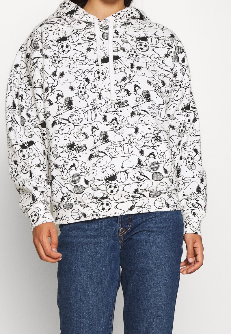 Felpa bianca con un motivo cartoon nero di palloni sportivi e personaggi, dotata di cappuccio con coulisse e polsini a costine.