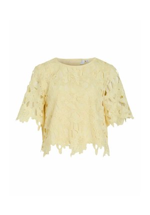 Top court jaune à manches courtes en dentelle avec des motifs floraux découpés et un ourlet et des manches festonnés.