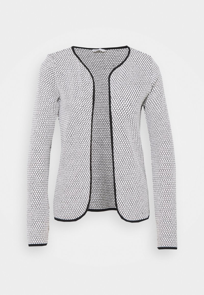Cardigan pour femmes blanc à ouverture devant, avec motif hexagonal noir et bordure noire aux bords et aux poignets, manches longues et encolure ronde.