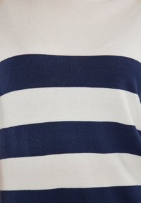 Marineblauwe en witte gestreepte brei stof, met brede horizontale strepen en een zachte textuur. Het ontwerp bevat afwisselende kleuren en een gladde afwerking.