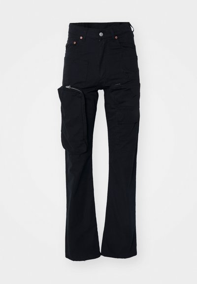 Black cargo pants made of durable fabric, featuring multiple pockets, a zippered side pocket, and a straight-leg design.