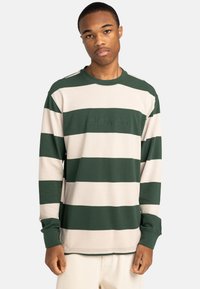 Long-sleeve striped sweatshirt in green and beige cotton, featuring a crew neck and embroidered logo at the chest. Flat seam accents.