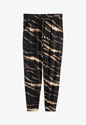 Black jogger pants with a tie-dye pattern in cream and light brown. Features an elastic waistband and side pockets, made from soft fabric.