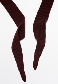 Dark maroon knitted scarf with textured rib pattern, laid flat with pointed ends twisted slightly against a white background.