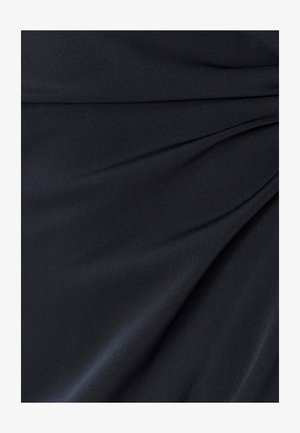 Tissu noir à texture lisse, présentant un drapé doux et des plis, créant un léger éclat sur toute la surface.