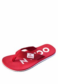 Red flip-flop sandal with white "OCEAN" text on the sole and a fabric strap featuring a white label with a red logo.