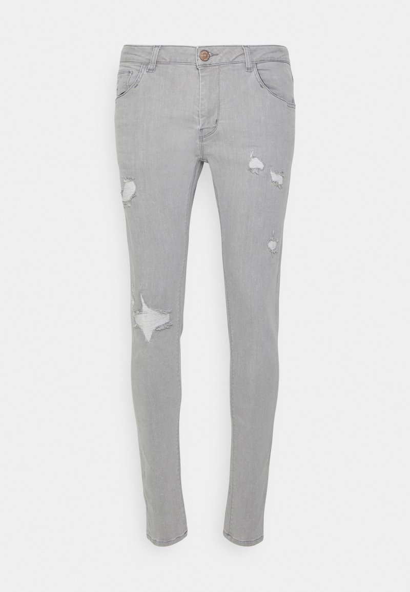 Grå denimjeans med slim fit, prydda med flera slitna lappar och ett stjärnformat rivsår. Klassisk femficksdesign med knappstängning.