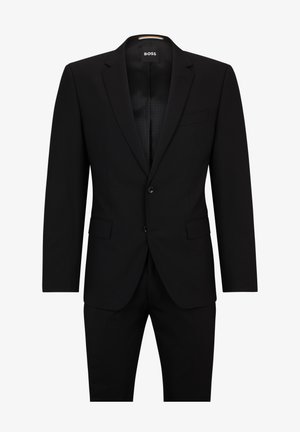 Blazer noir en tissu lisse. Équipé d'une fermeture à un bouton, de revers en notch et d'une poche poitrine avec une coupe ajustée.