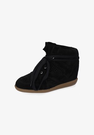 Black suede wedge sneaker with large black laces, perforated side panels, and a brown rubber sole.