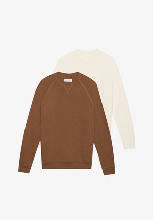 Dos sudaderas de manga larga: una marrón con textura acanalada y mangas raglán, y una de color crema, de tela lisa, ambas con cuello redondo.