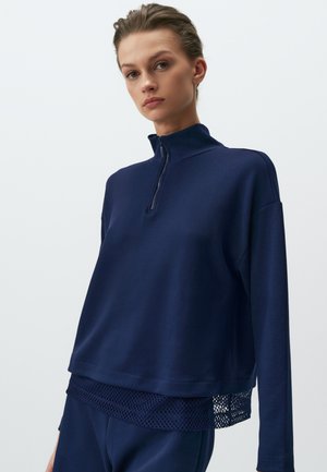 Pullover blu navy con zip realizzato in tessuto morbido, dotato di un pannello in rete all'orlo, con una vestibilità comoda e un design con colletto alto.