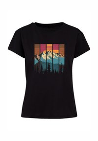 Black cotton t-shirt featuring a colorful mountain scene graphic, with shades of blue, orange, and pink, and vertical lines in the background.