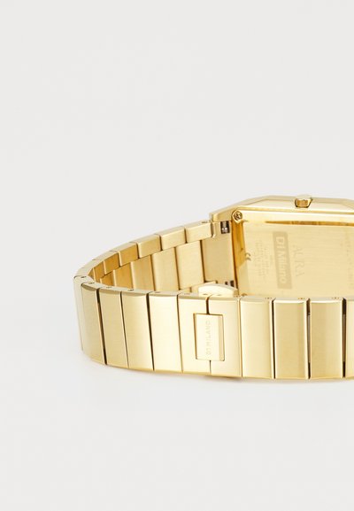 Gold metal watch with a rectangular case and a linked bracelet. Features a textured finish and a clasp with an engraved logo.