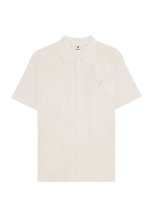 Short-sleeve cream knit polo shirt with textured pattern, button front, and small embroidered logo on left chest.