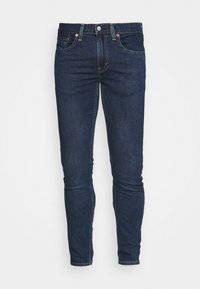Jeans de mezclilla azul oscuro con corte ajustado, que cuentan con un cierre estándar de botón y cremallera, cinco bolsillos y detalles de costura sutiles.