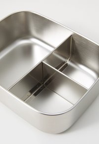 Stainless steel lunchbox with rounded edges, three compartments, smooth texture, and a brushed finish, designed for easy cleaning and storage.