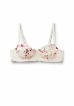 Kremowy biustonosz z fiszbinami, regulowanymi ramiączkami oraz koronkowymi miseczkami ozdobionymi różowym i czerwonym kwiatowym haftem.