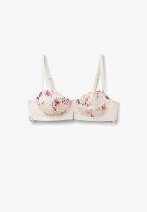 Kremowy biustonosz z fiszbinami, regulowanymi ramiączkami oraz koronkowymi miseczkami ozdobionymi różowym i czerwonym kwiatowym haftem.