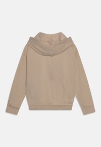 Huvtröja i beige färg gjord av mjukt material, med avslappnad passform, ribbade mudd och en liten logotypdetalj på ärmen.