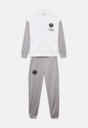 Hvit og grå treningsdrakt med glidelåsjakke og bukser, med Paris fotballklubb-logo og Qatar Airways sponsorbranding.